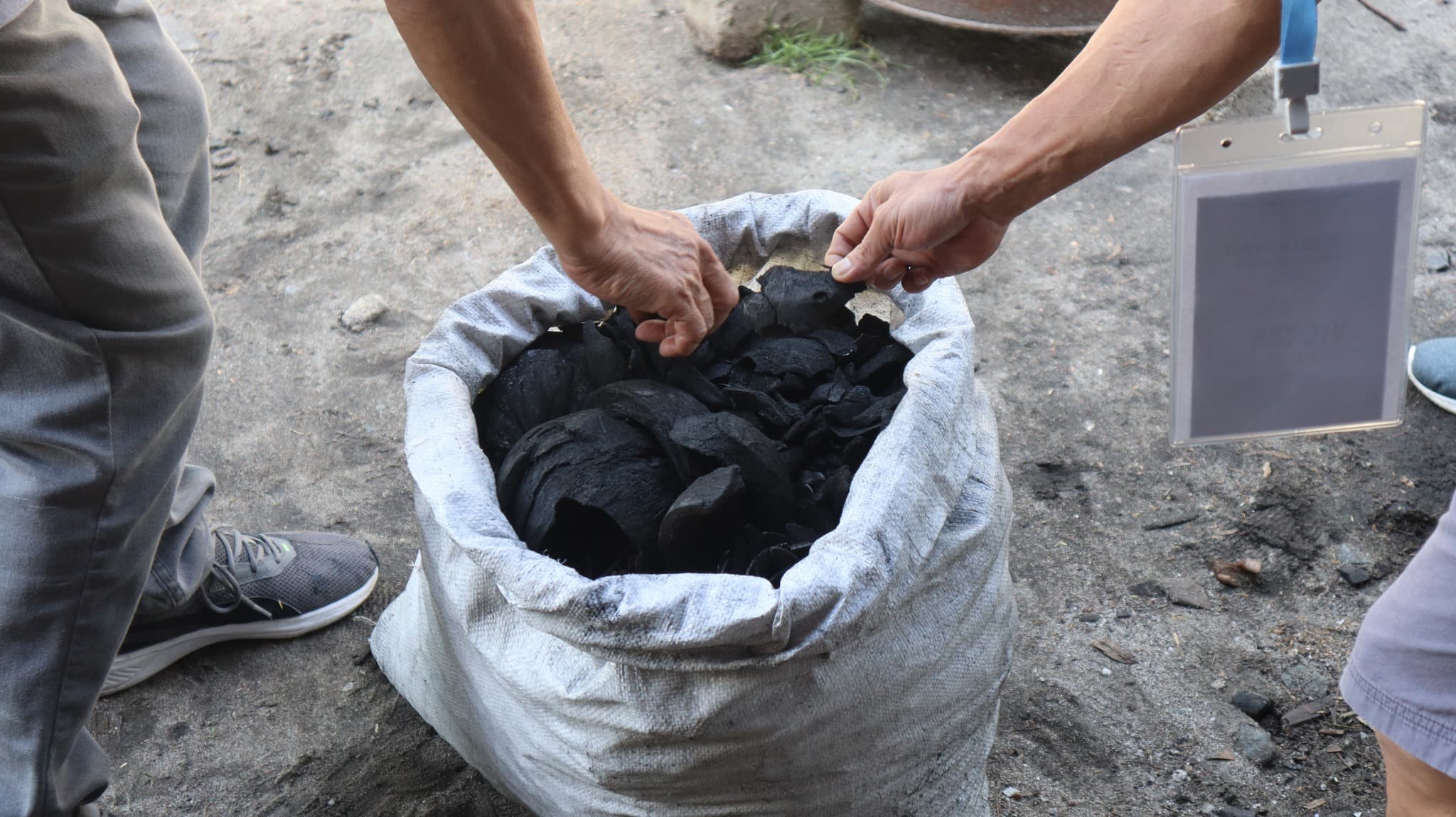 Participants learning biochar production techniques